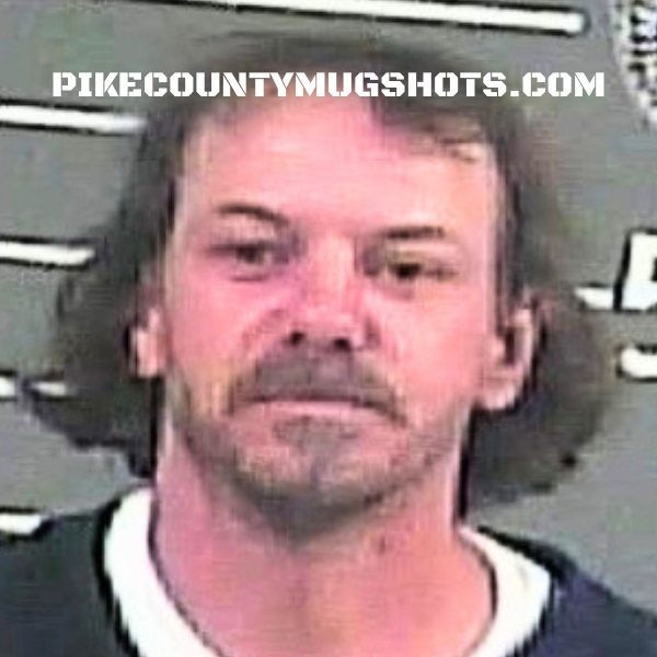 Mugshot of a man with long hair